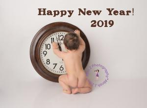 Naked bum baby with big clock about to strike midnight on New Years 2019